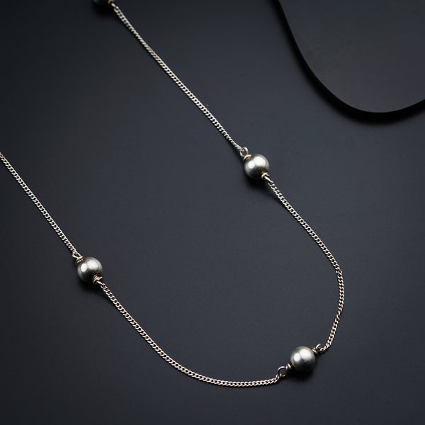 a close up of a necklace on a black surface