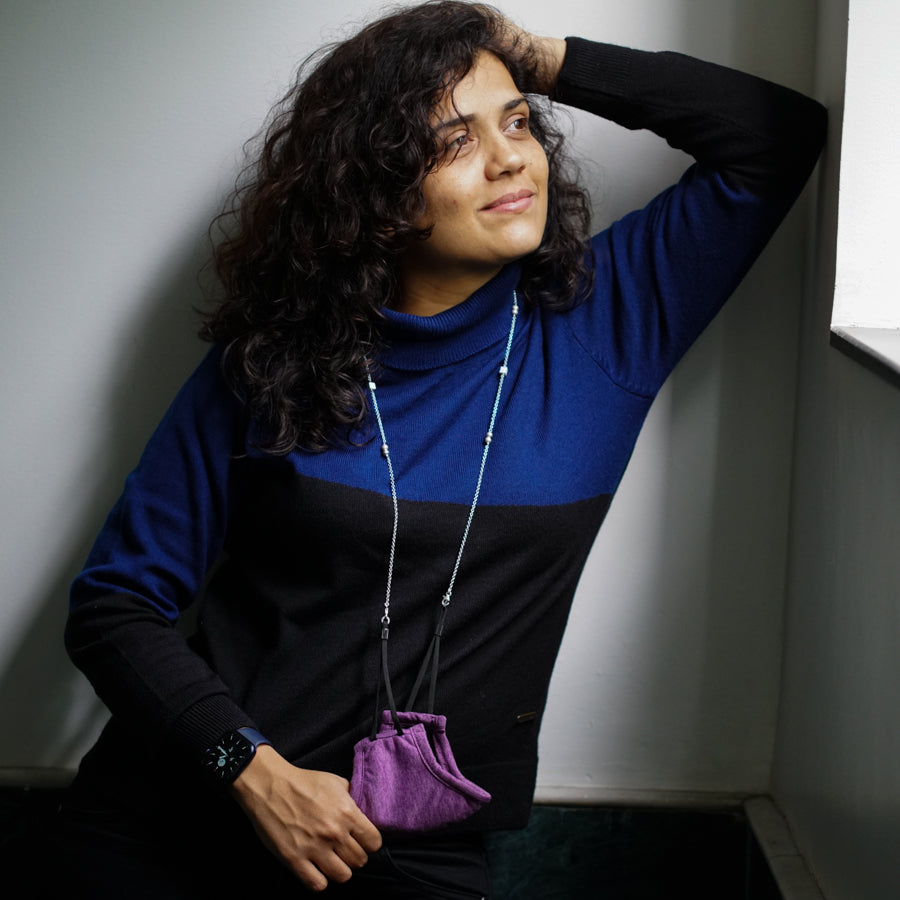 a woman leaning against a wall with her hand on her head