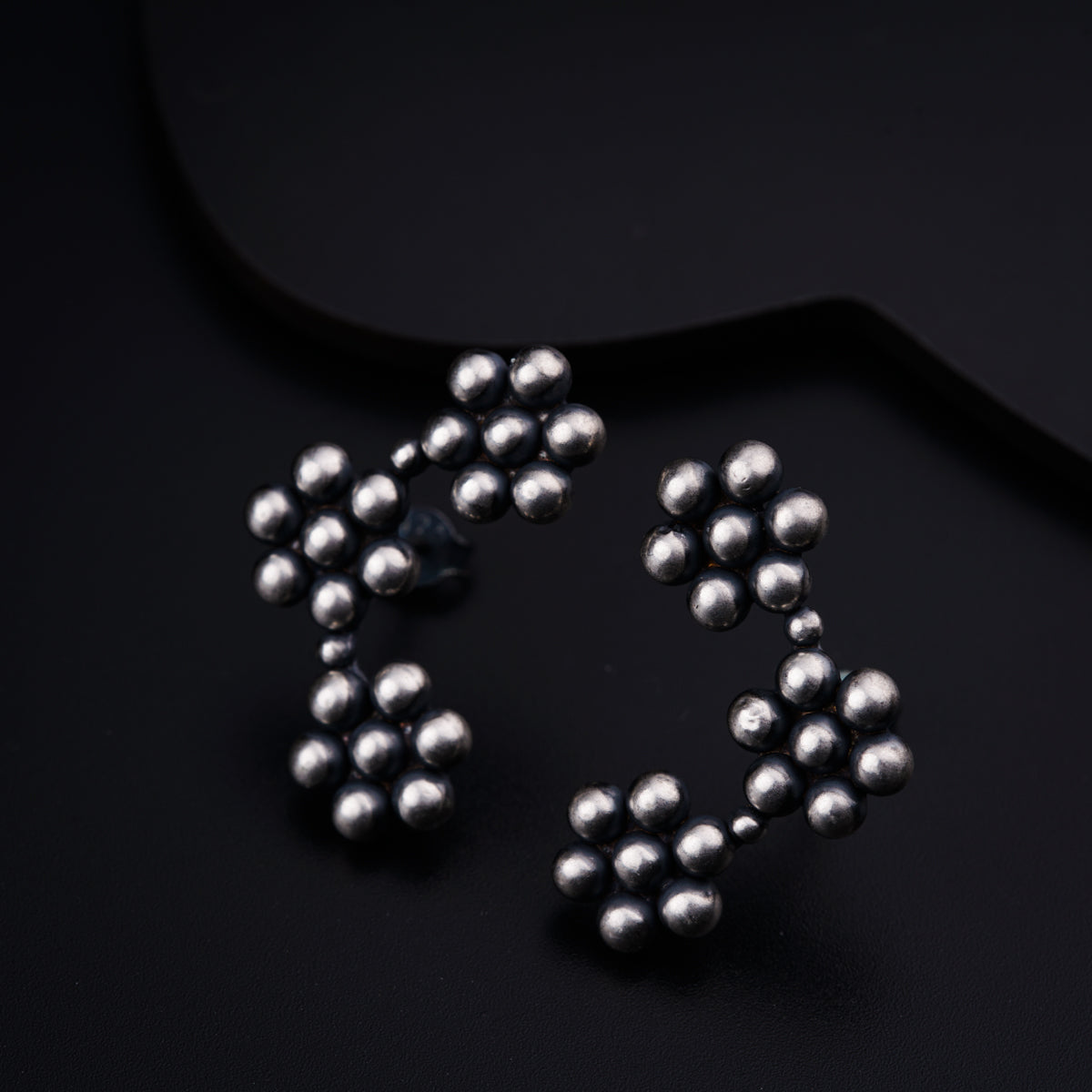 a pair of silver balls sitting on top of a black surface