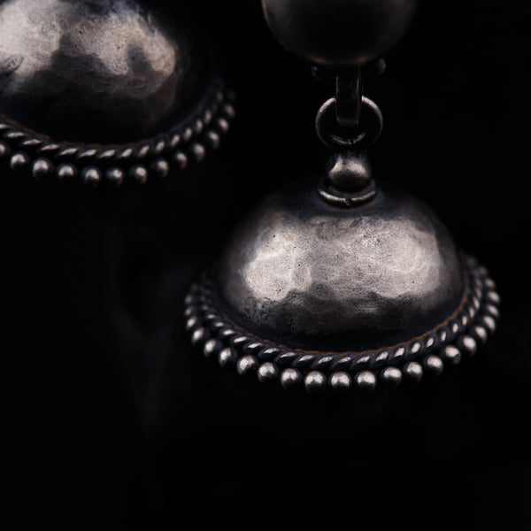 a close up of a metal object on a black background