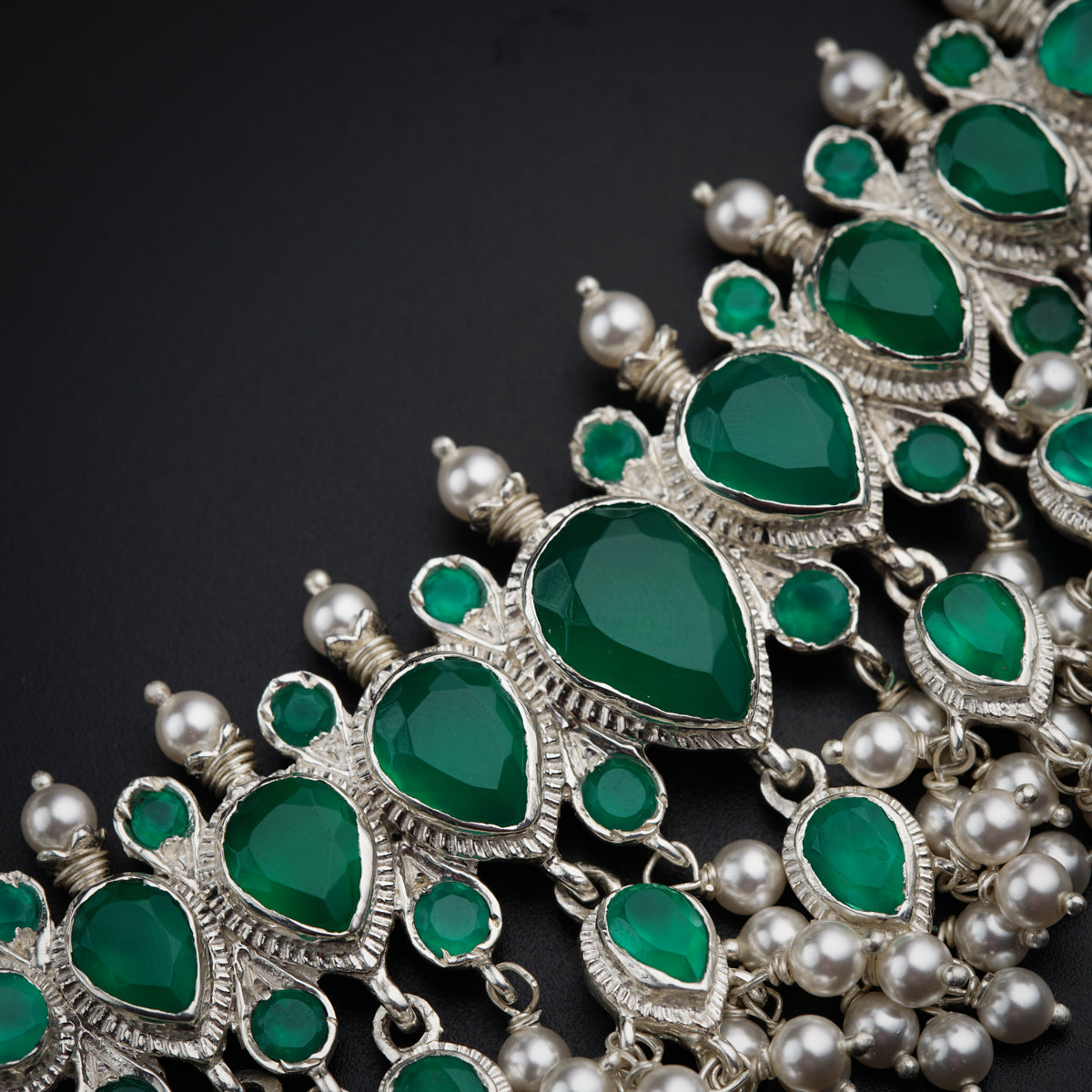 a close up of a bunch of green jewels