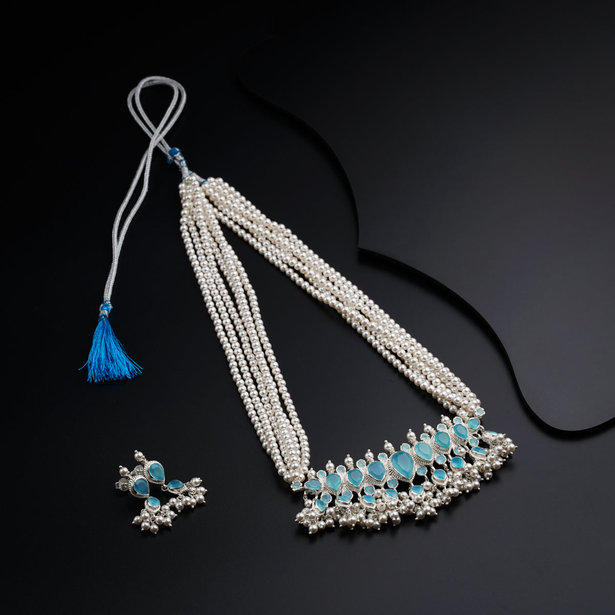 a necklace and earring with a tassel