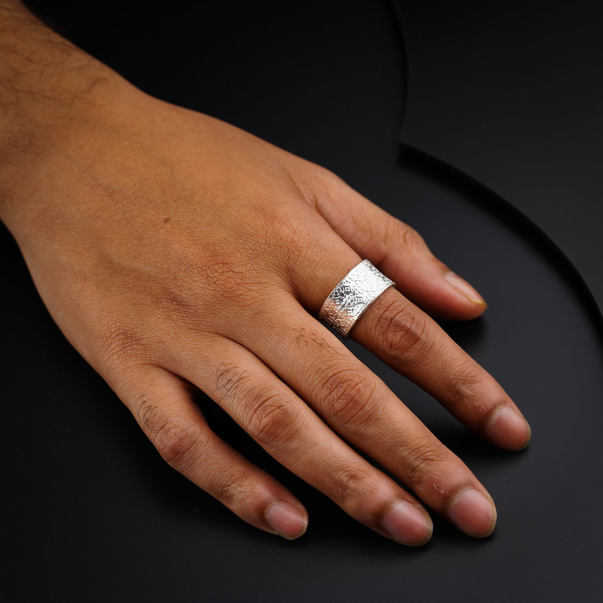 a person's hand with a ring on it