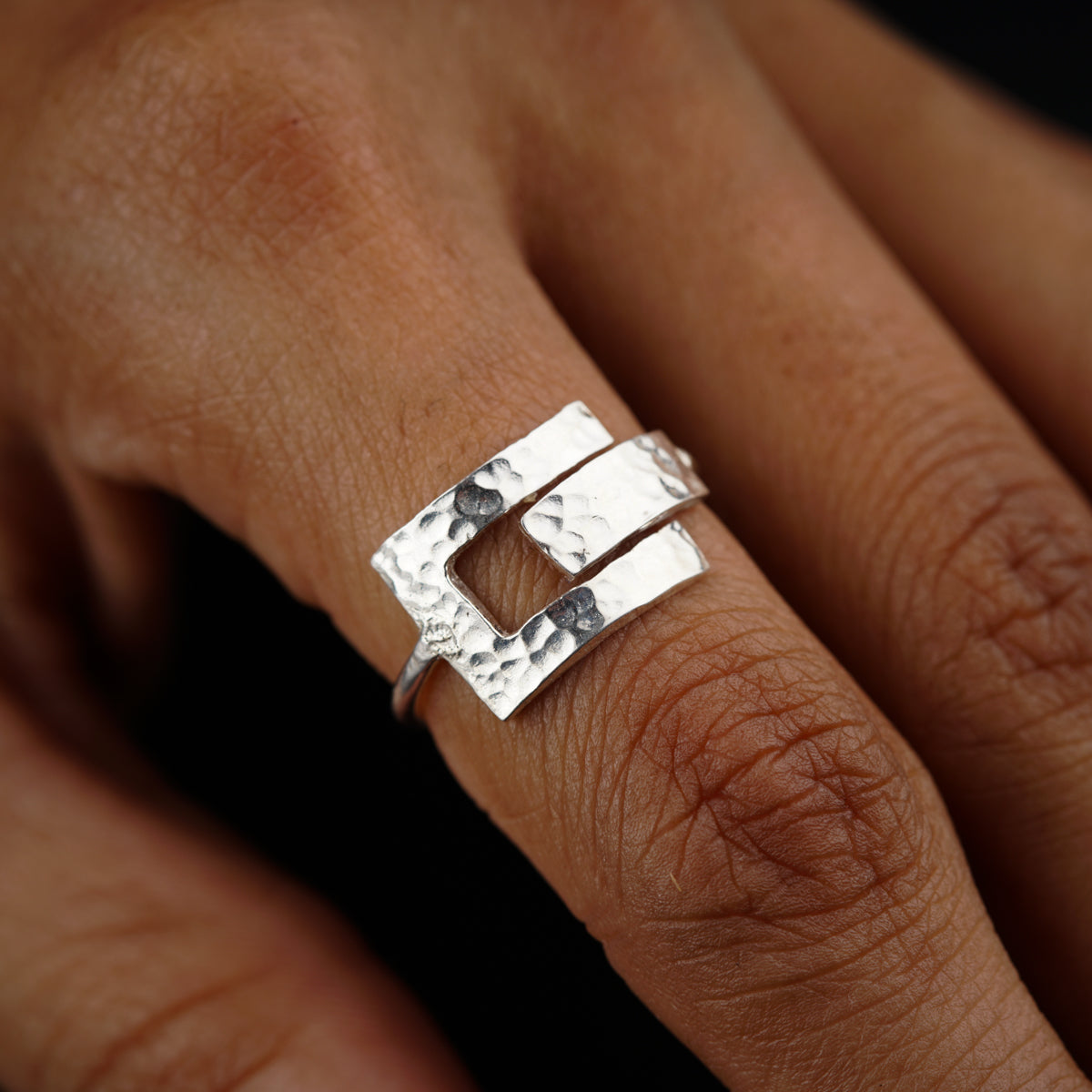 a close up of a person's hand with a ring on it