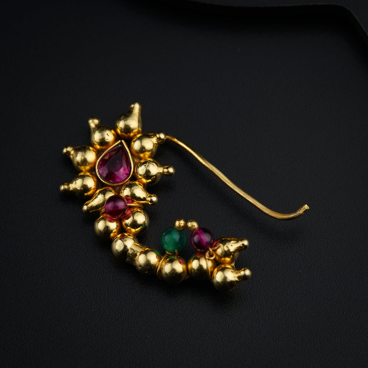 a pair of gold earrings with red and green stones