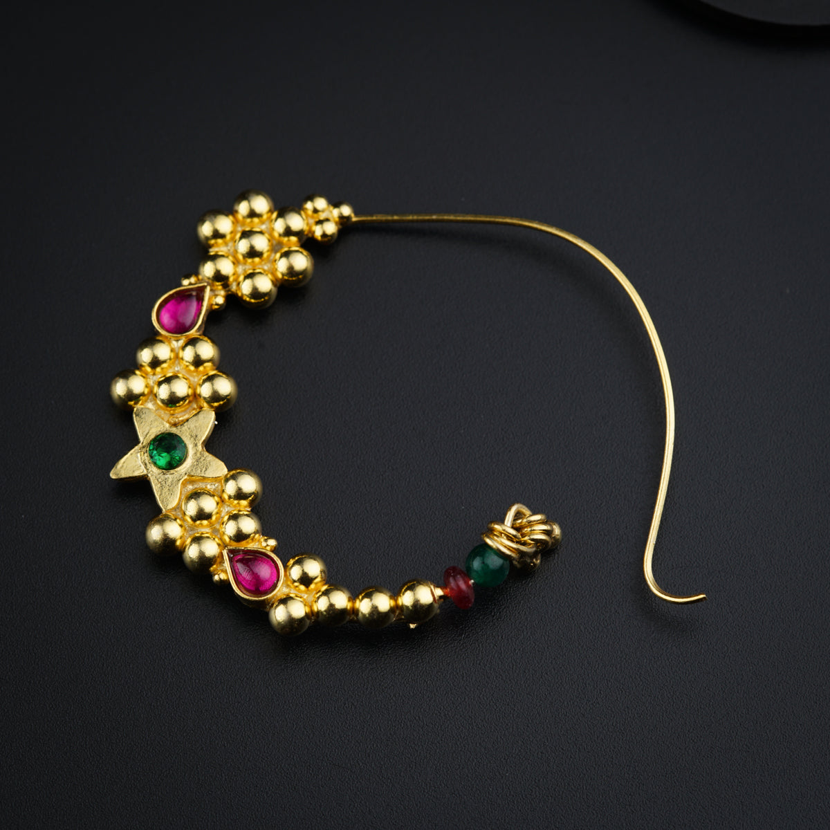 a close up of a gold bracelet with beads