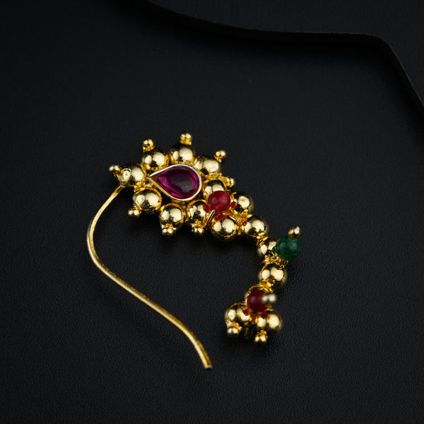 a close up of a brooch on a black surface