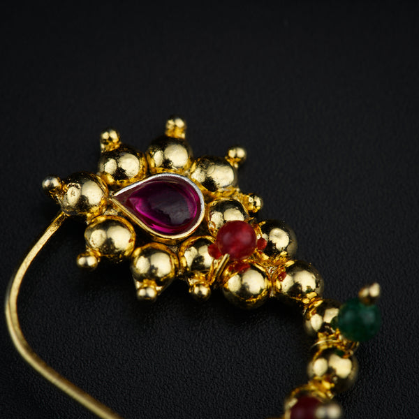 a close up of a brooch on a black surface