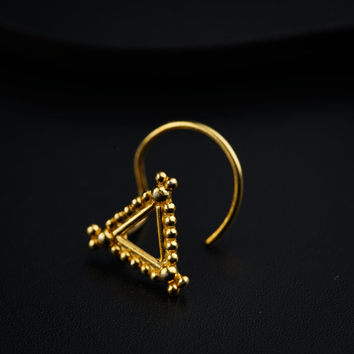 a gold ring with a triangle on it