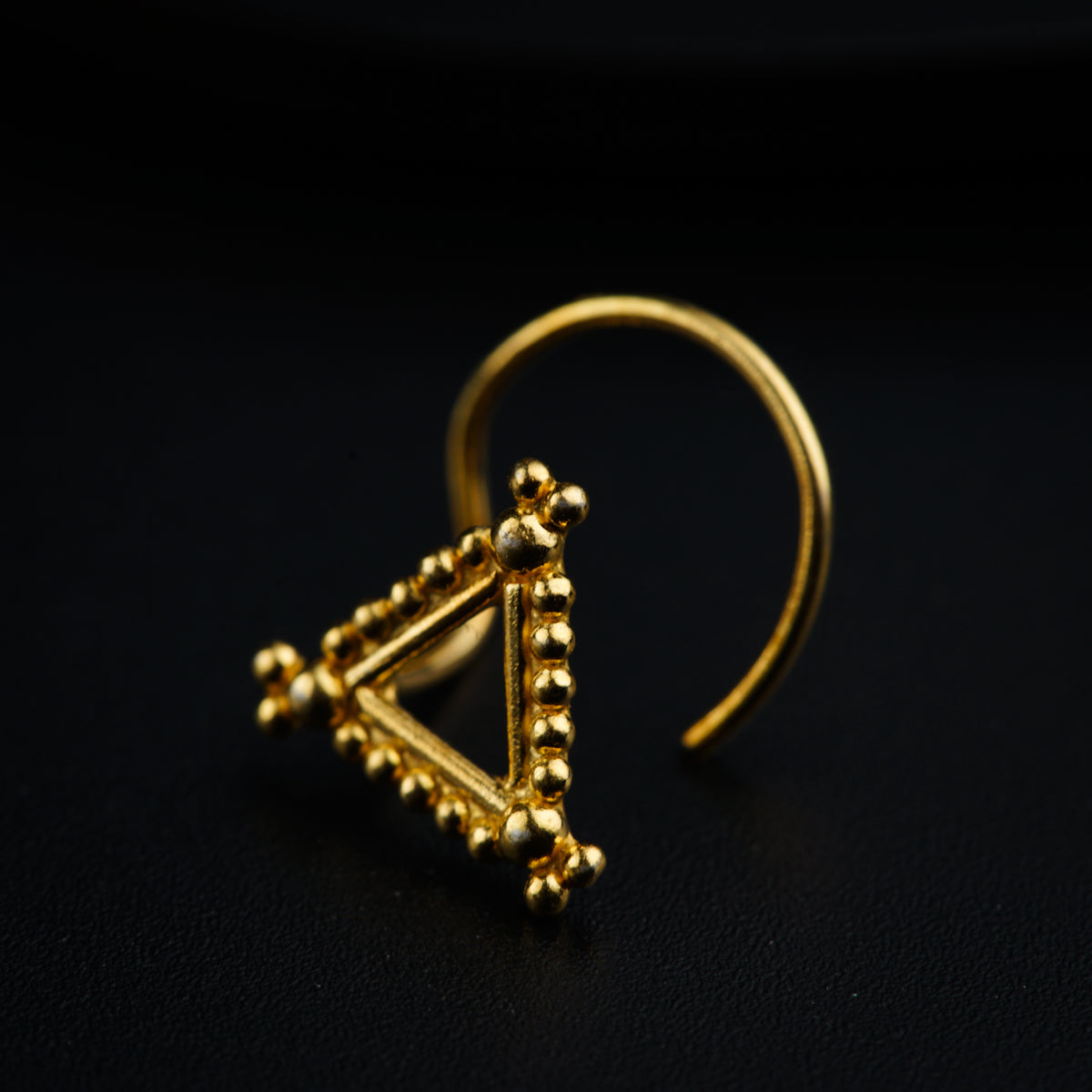 a gold ring with a triangle on it