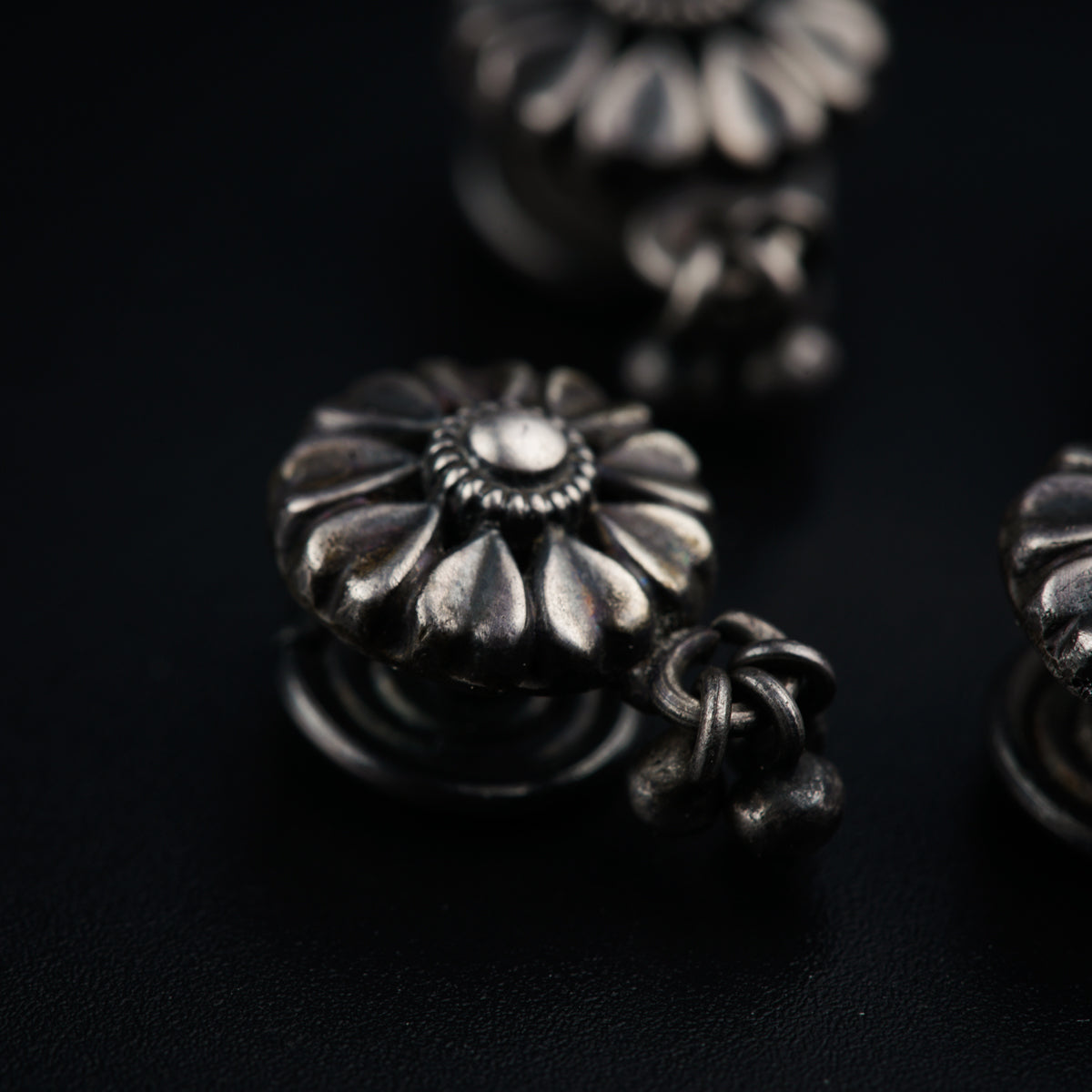a group of metal knobs sitting on top of a black surface