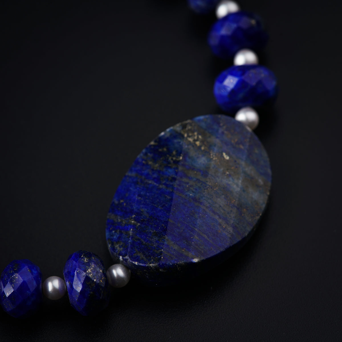 a necklace with a large blue stone on it