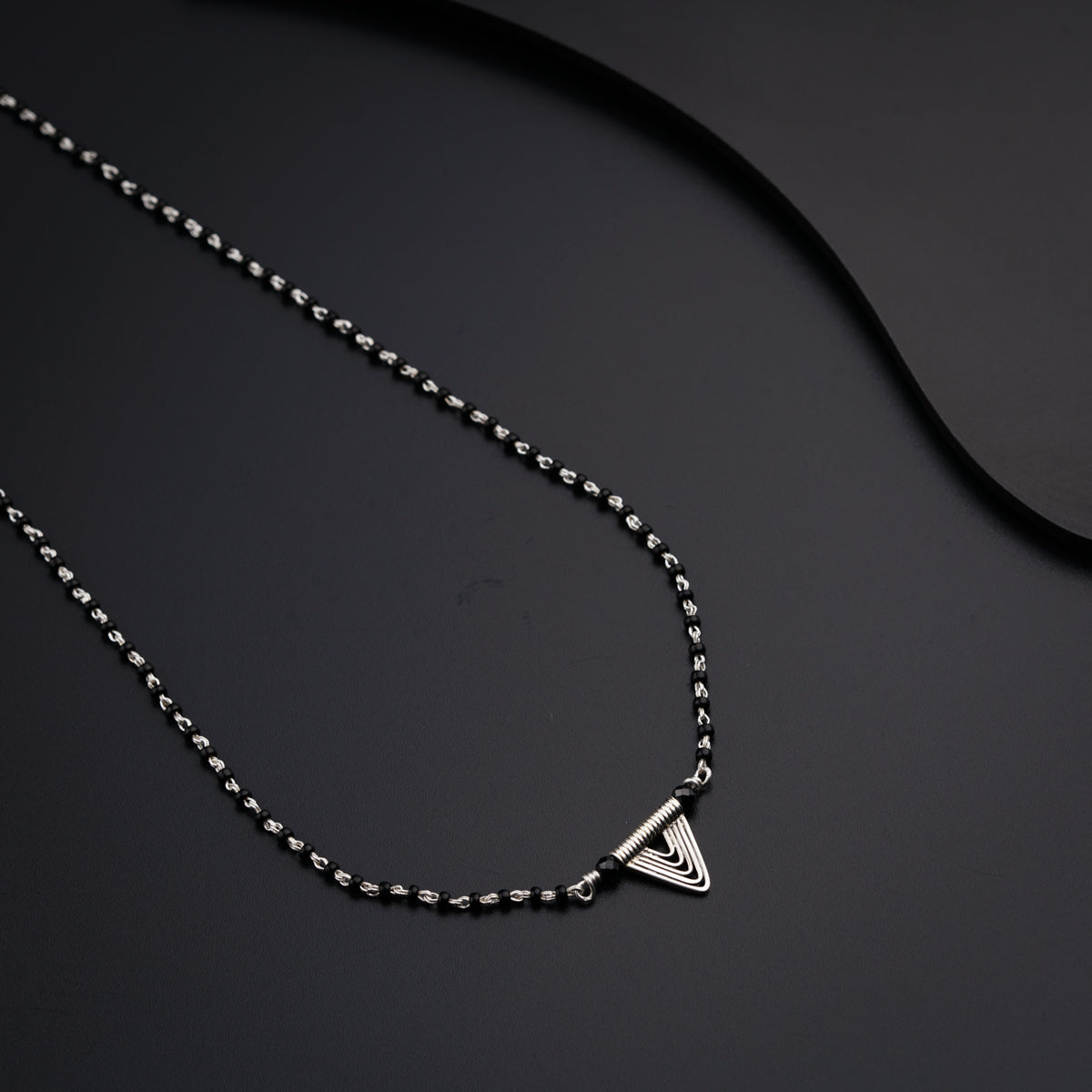 a necklace that has a triangle on it