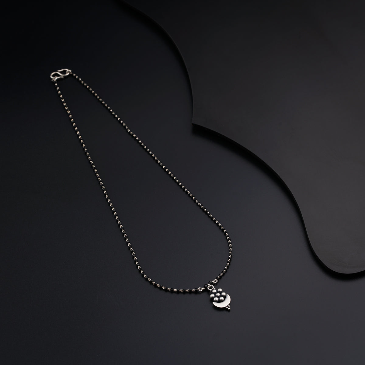 a necklace with a crescent and a star on it