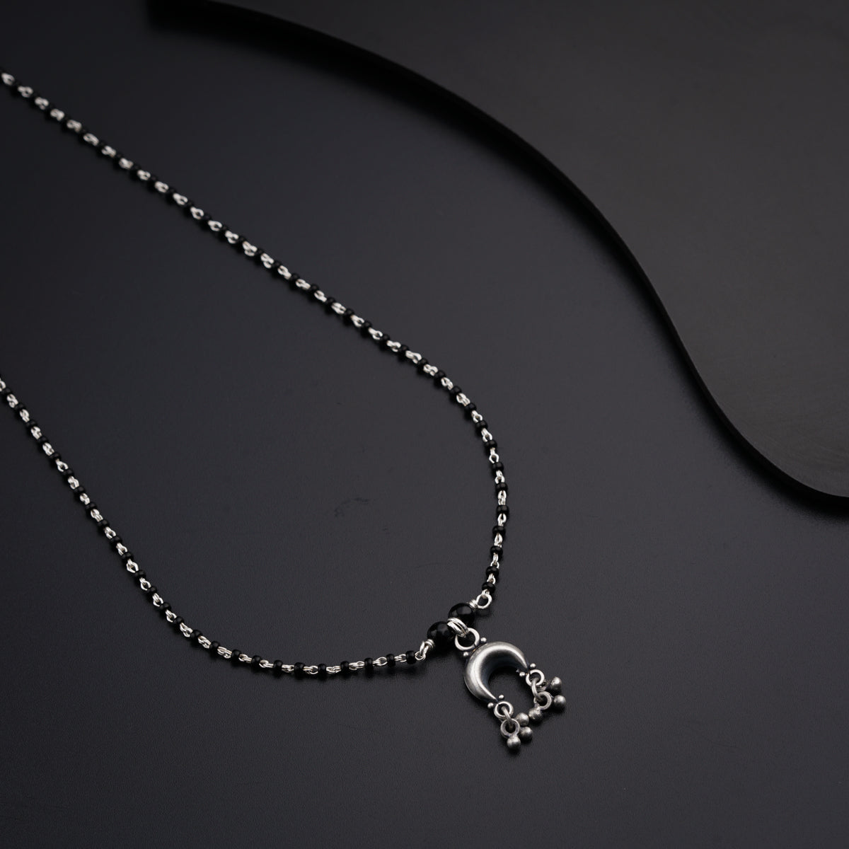 a necklace with a skull and cross on it