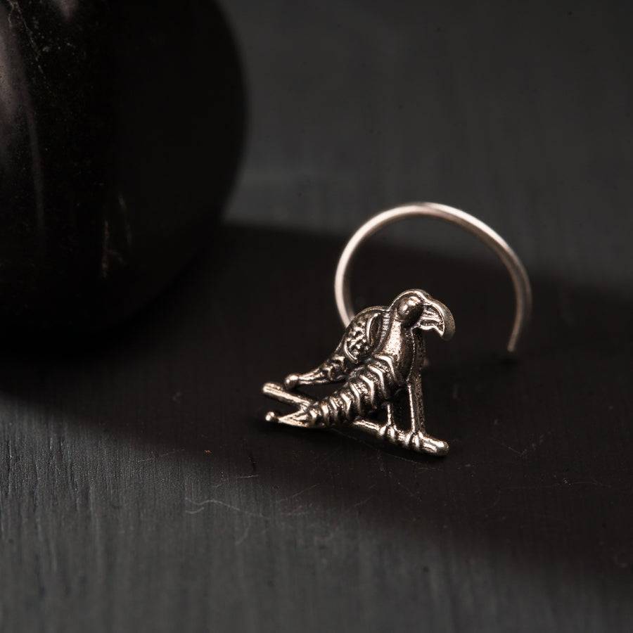 a silver ring with a skeleton sitting on top of it