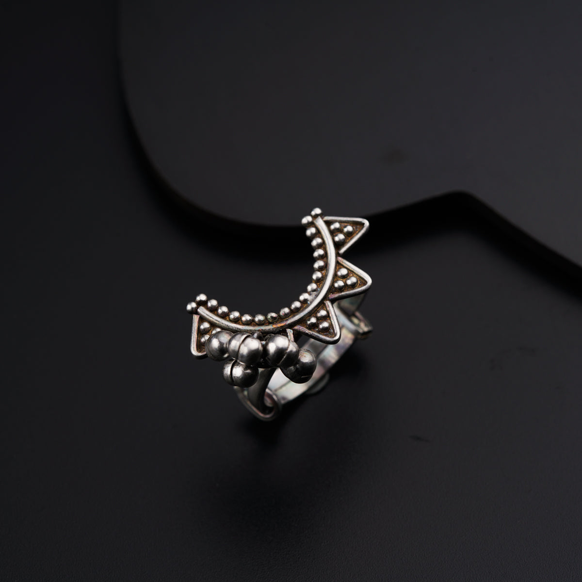 a close up of a ring on a black surface