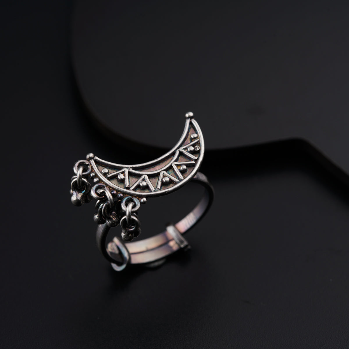 a close up of a ring on a black surface