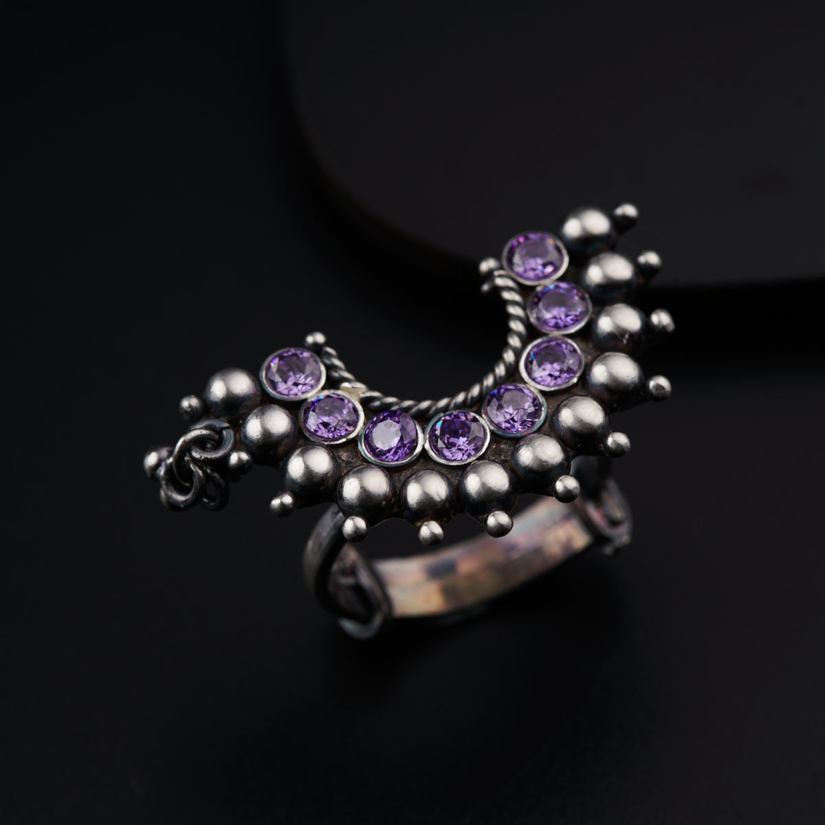 a close up of a ring on a black surface