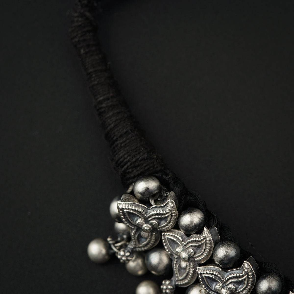 a close up of a necklace on a black background