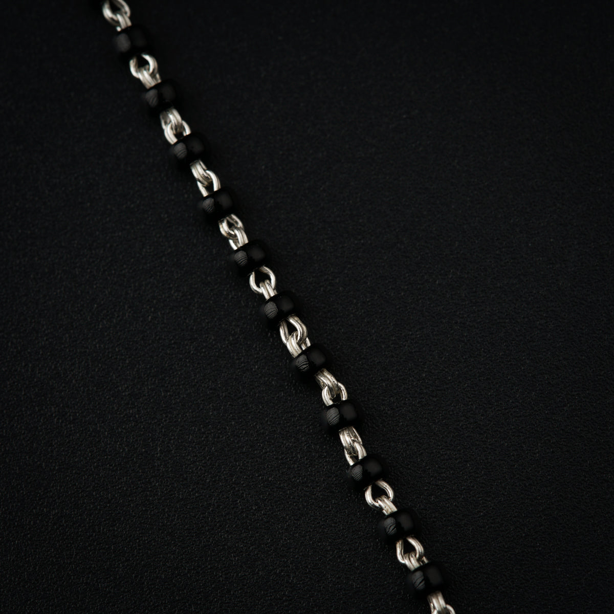a close up of a chain on a black surface