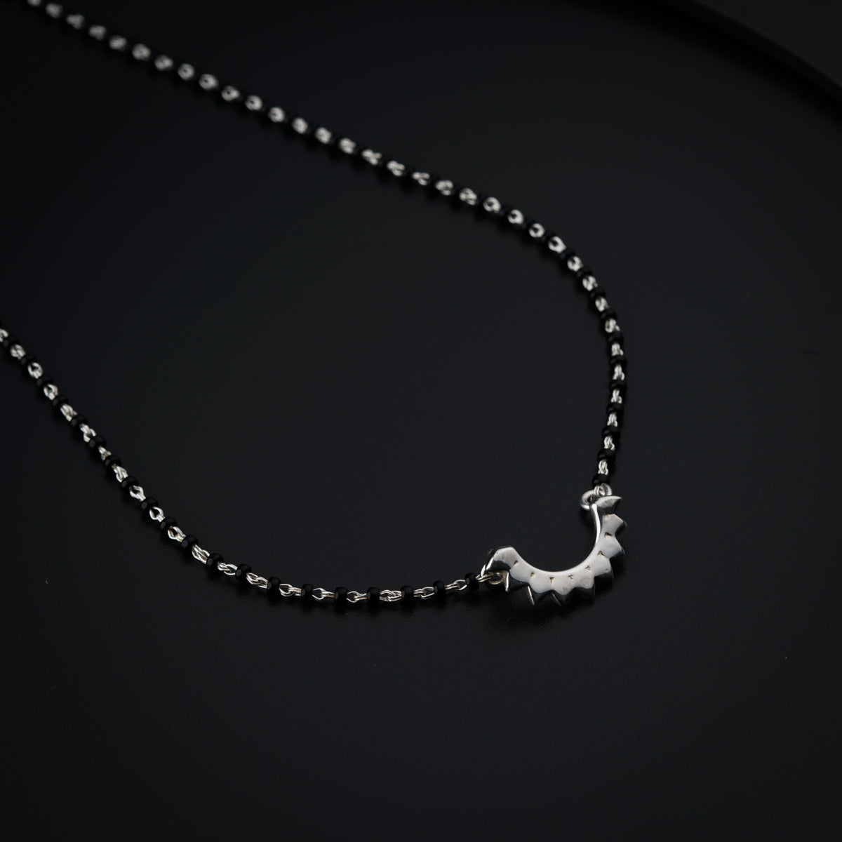 a silver necklace with a giraffe on it