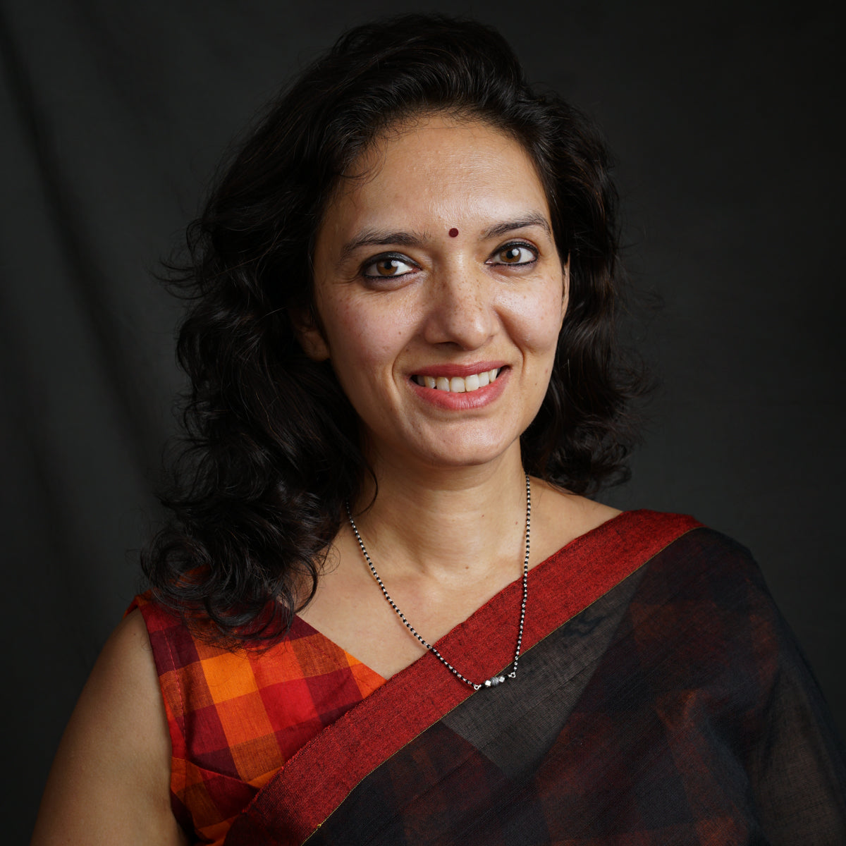 a woman in a red and black sari