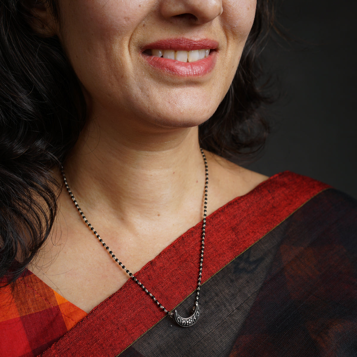 a close up of a person wearing a necklace