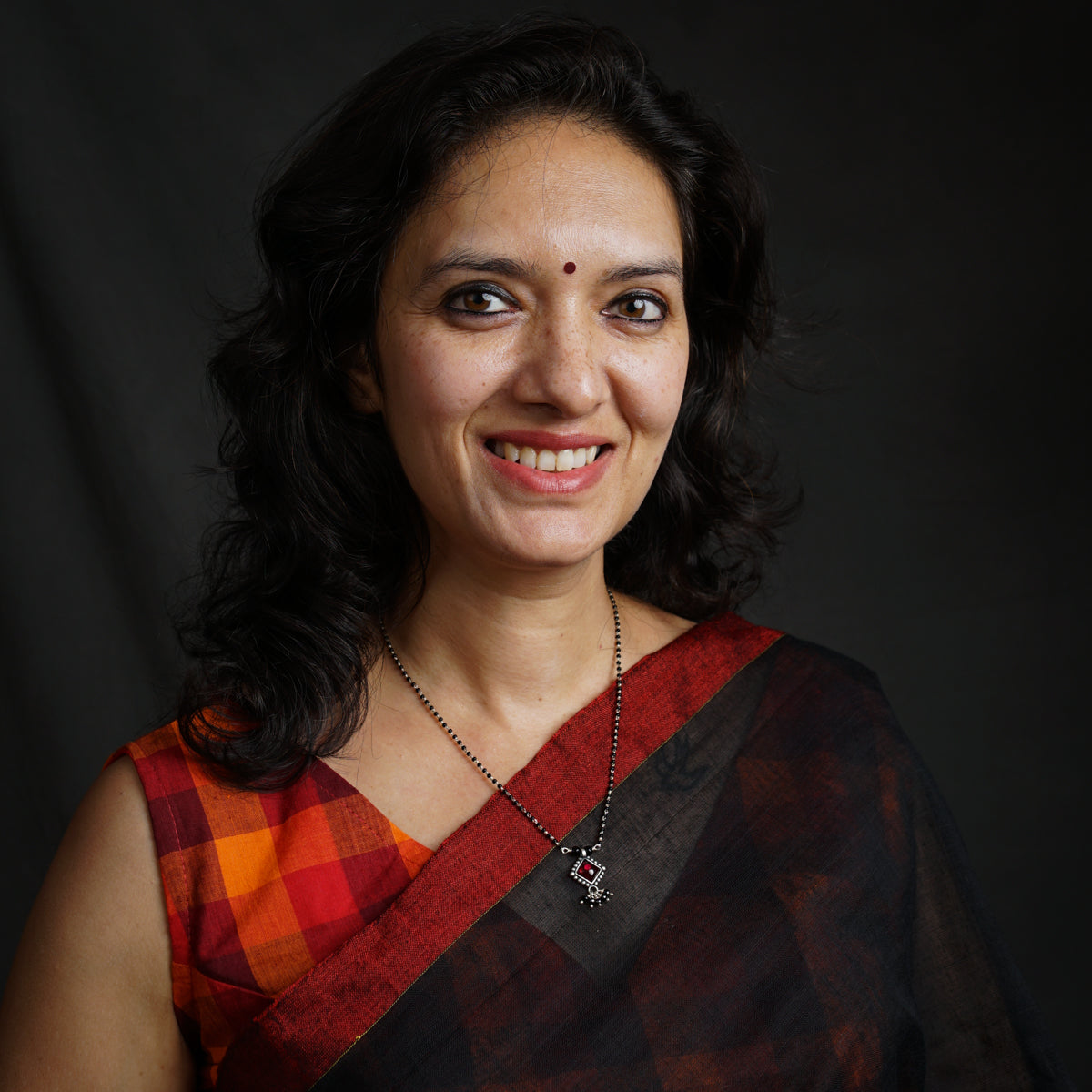 a woman in a red and black sari