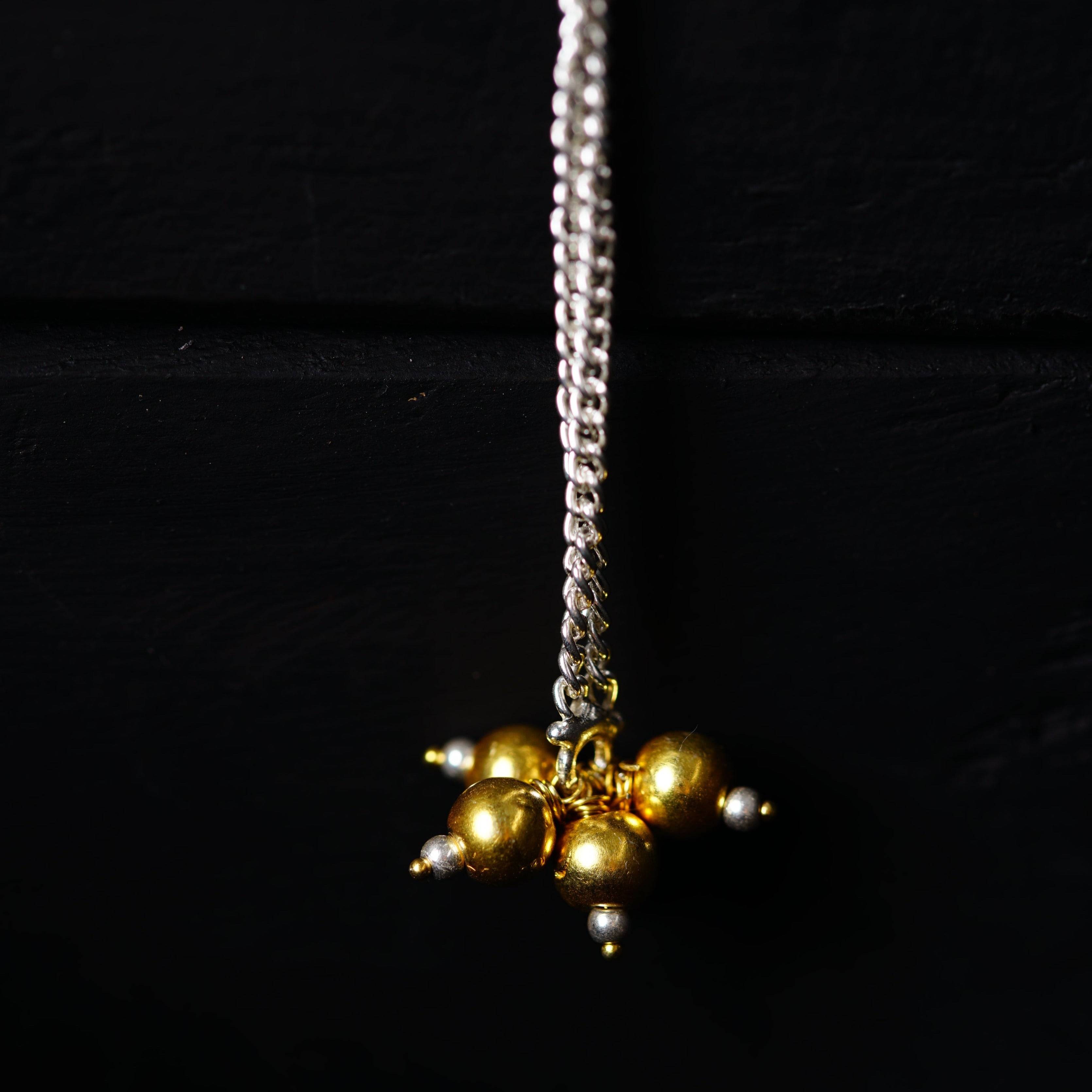 a close up of a necklace on a chain