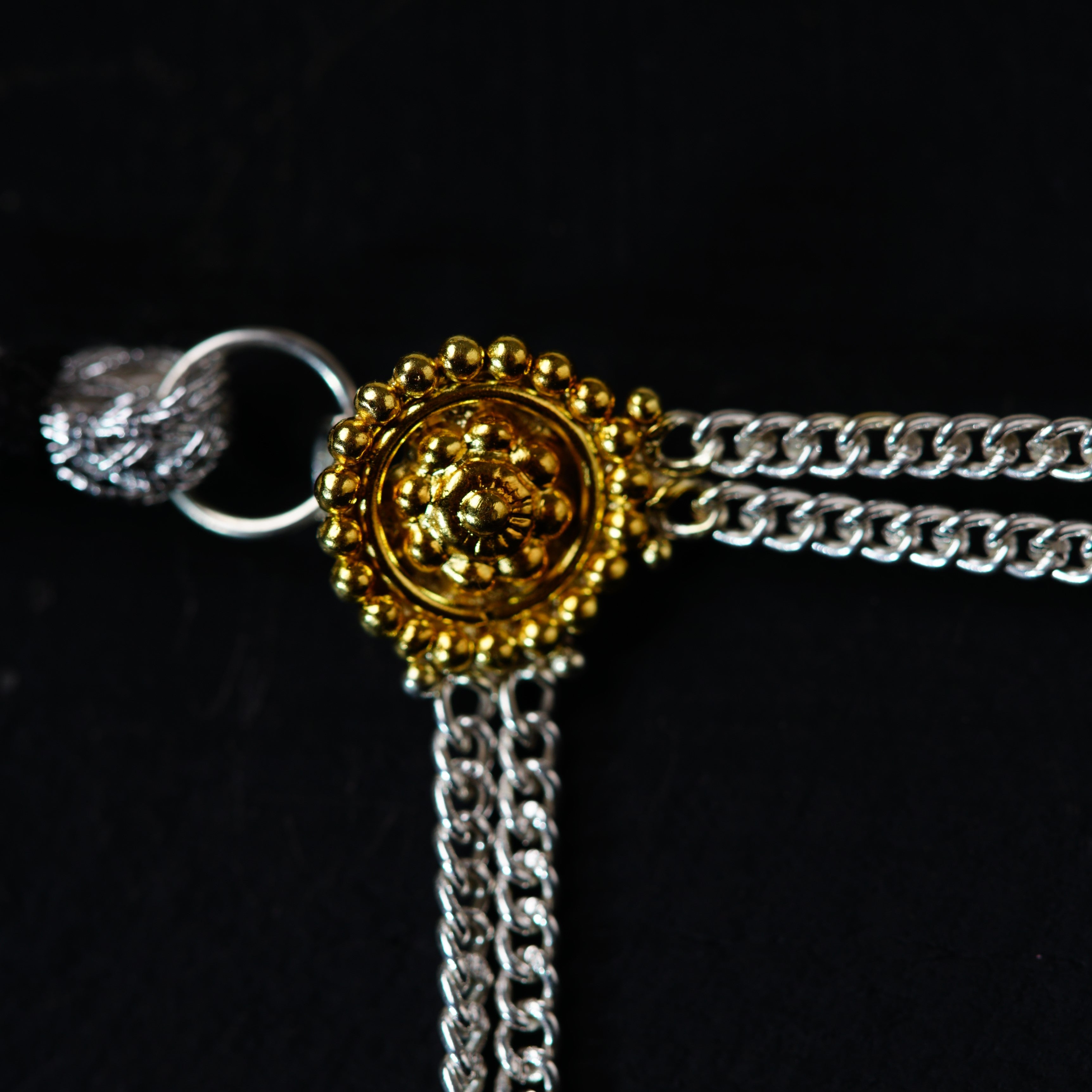 a gold and silver bracelet with a lion head on it