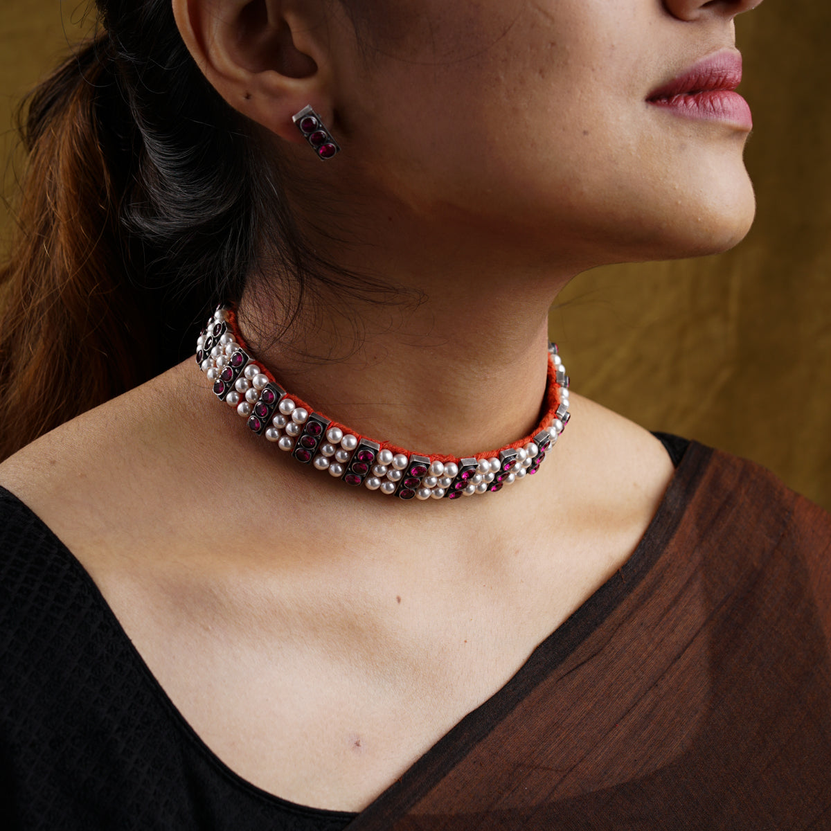 a close up of a woman wearing a necklace