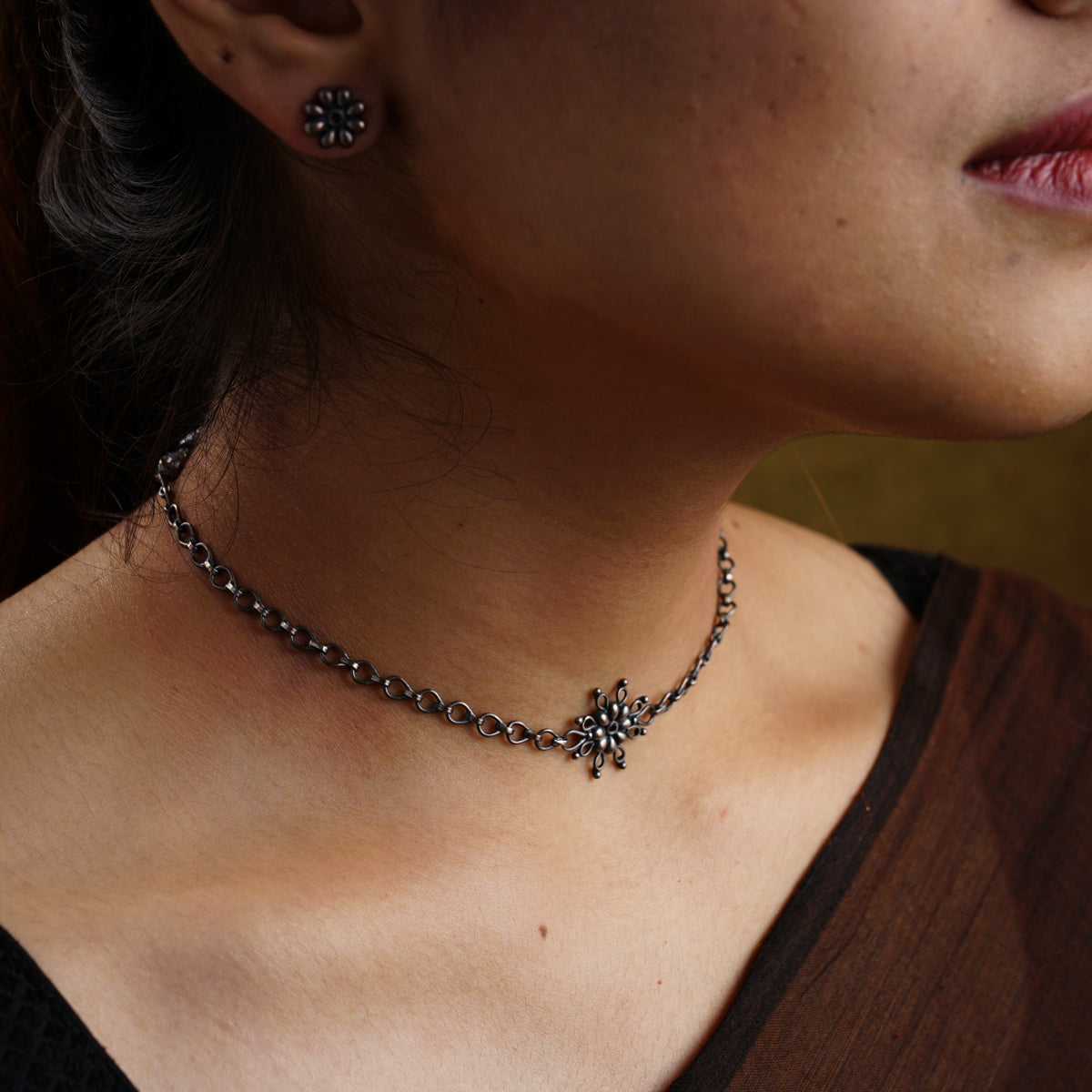 a close up of a woman wearing a necklace