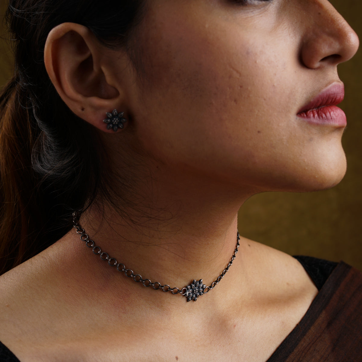 a close up of a woman wearing a necklace