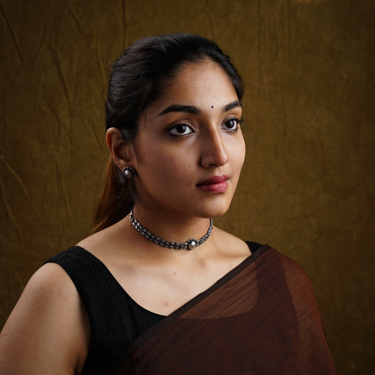 a woman in a sari with a necklace on her neck