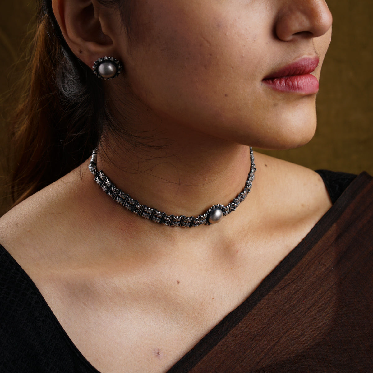 a close up of a woman wearing a necklace