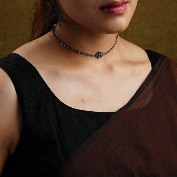 a woman in a brown sari poses for a picture
