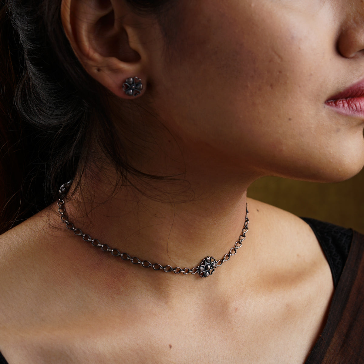 a close up of a woman wearing a necklace