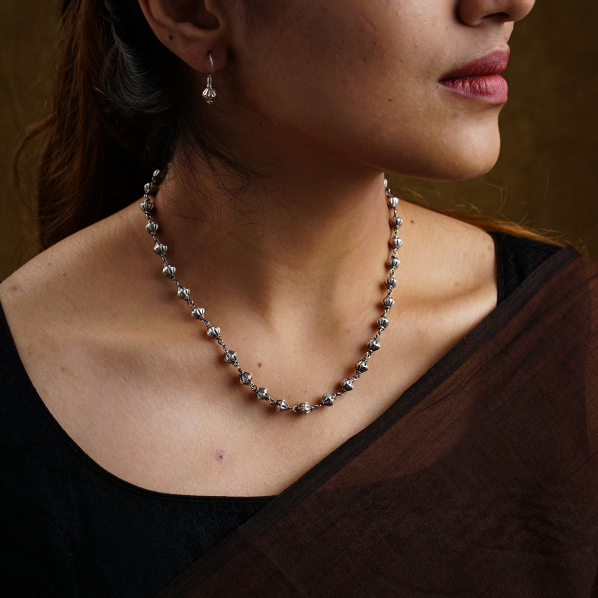 a close up of a woman wearing a necklace