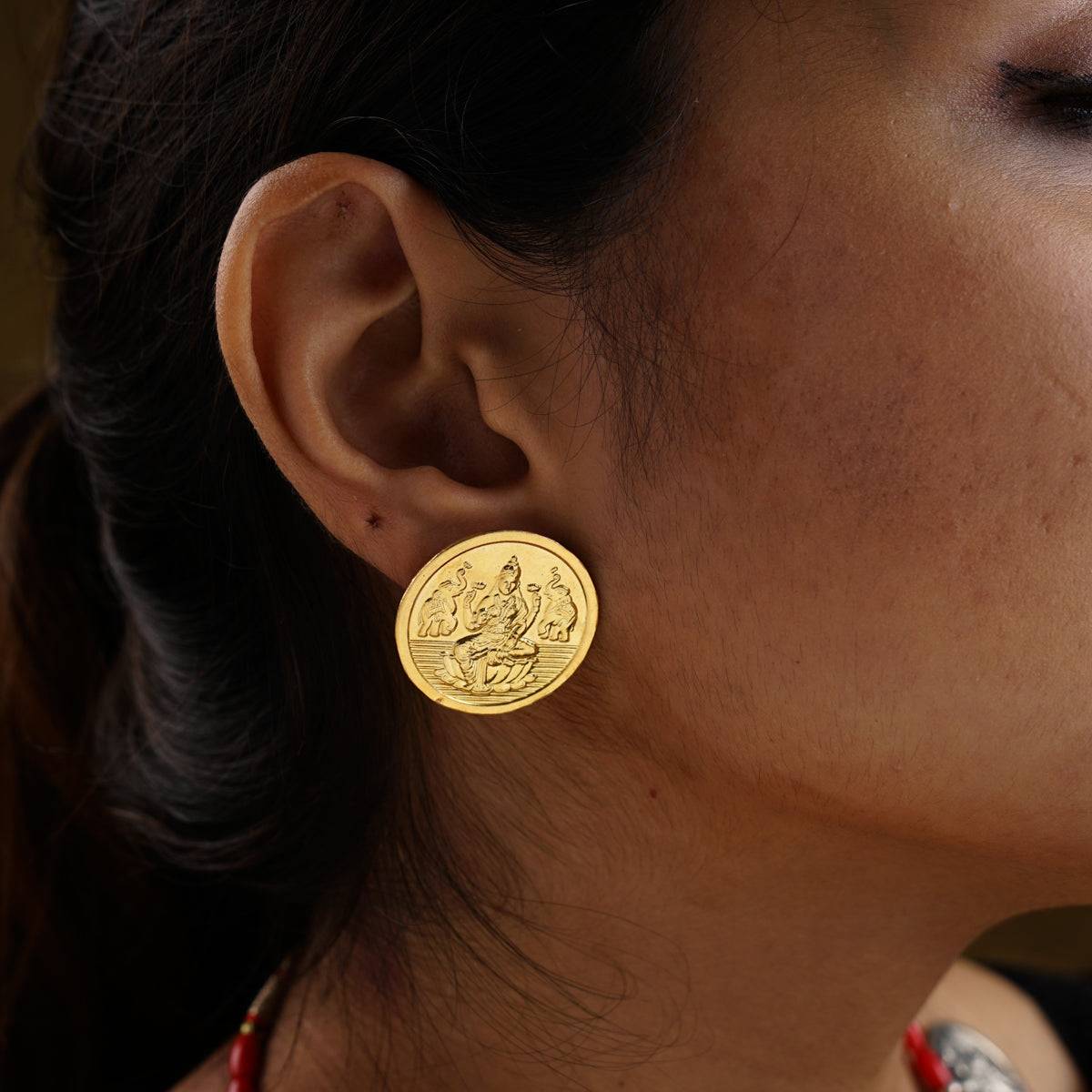 a close up of a person wearing a pair of earrings
