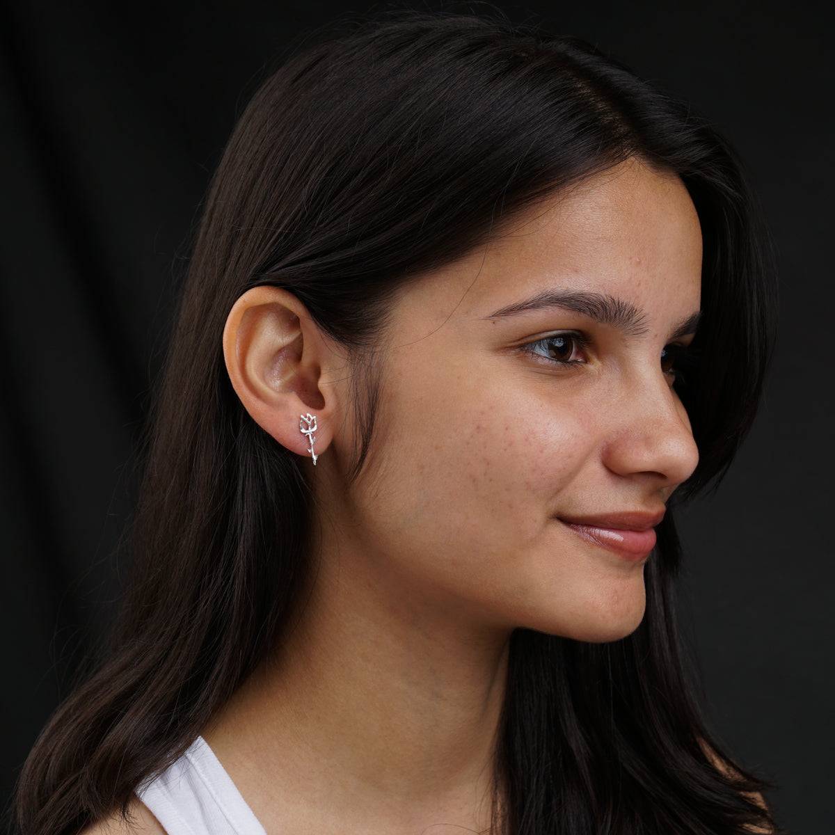 Model styling rose silver earrings with modern look