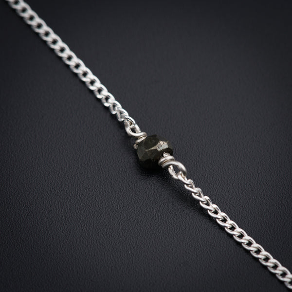 a close up of a chain on a black surface