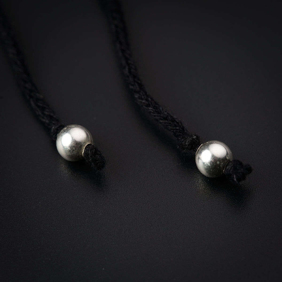 a pair of pearls on a black cord