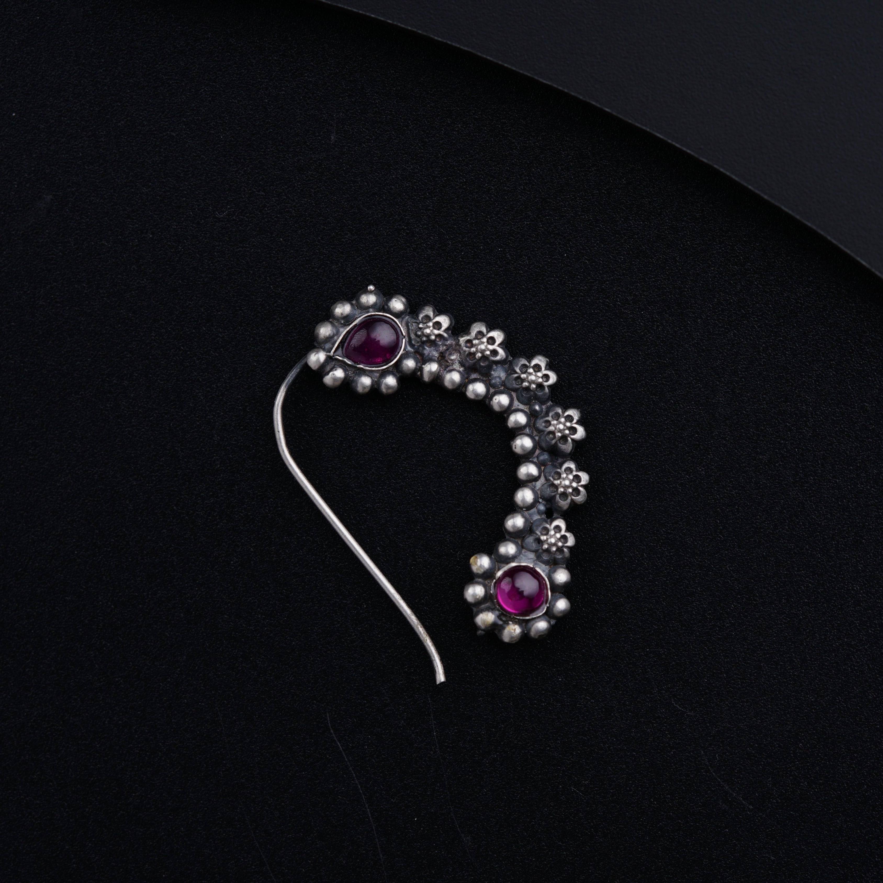 a brooch with a bunch of beads on it