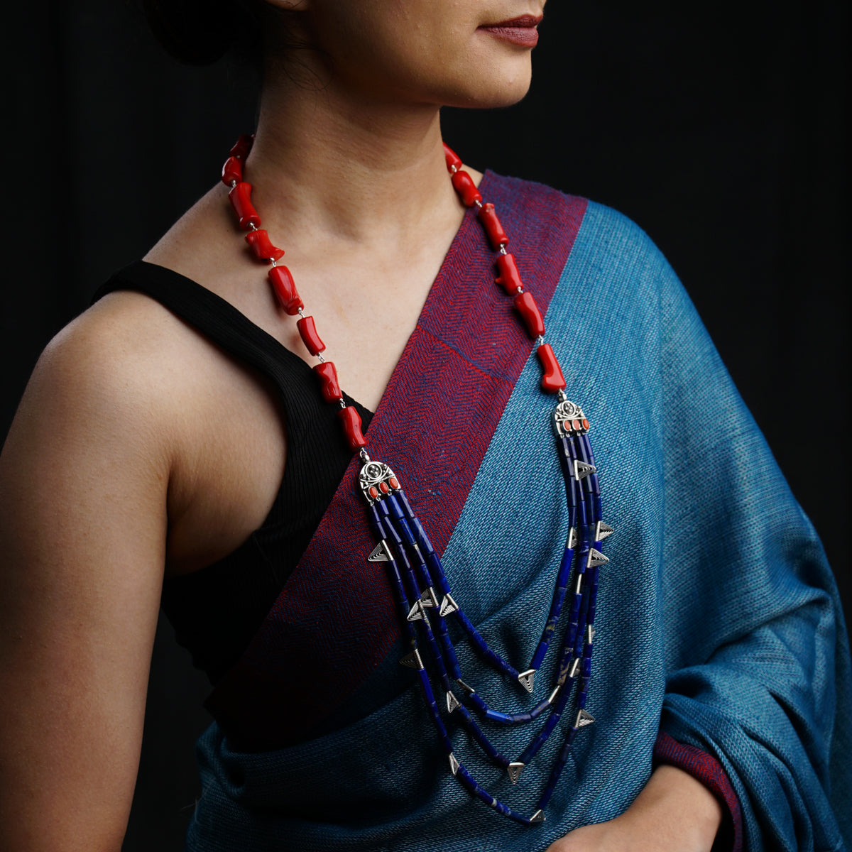 a woman wearing a blue and red necklace