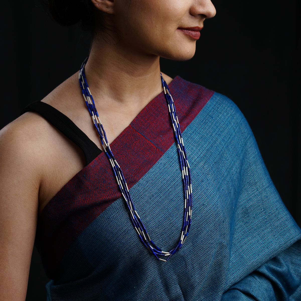 a woman wearing a blue and red sari