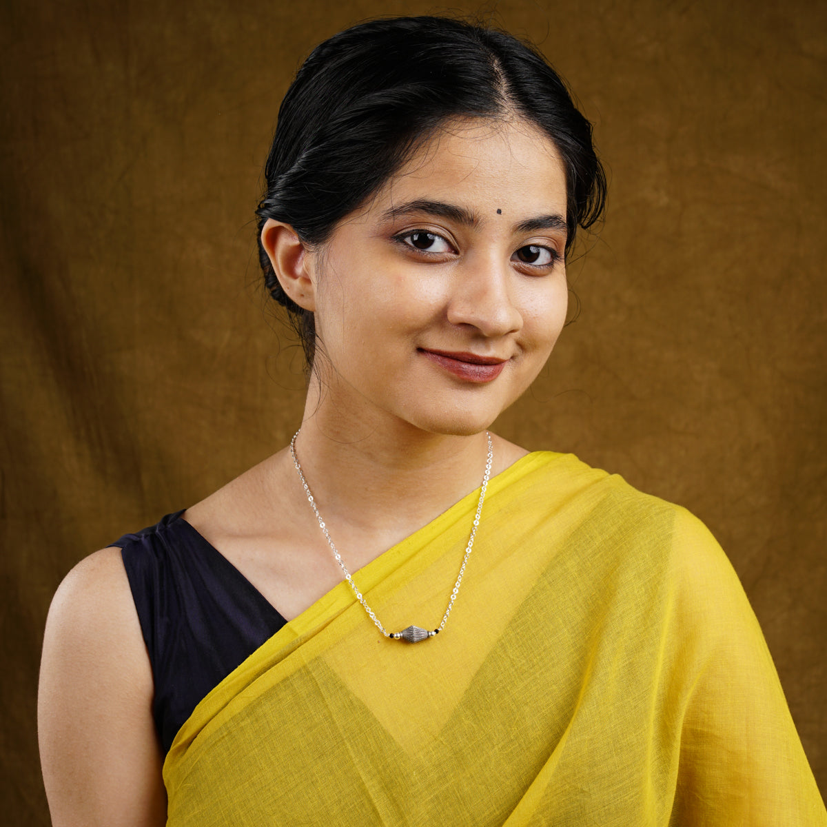 a woman in a yellow sari posing for a picture