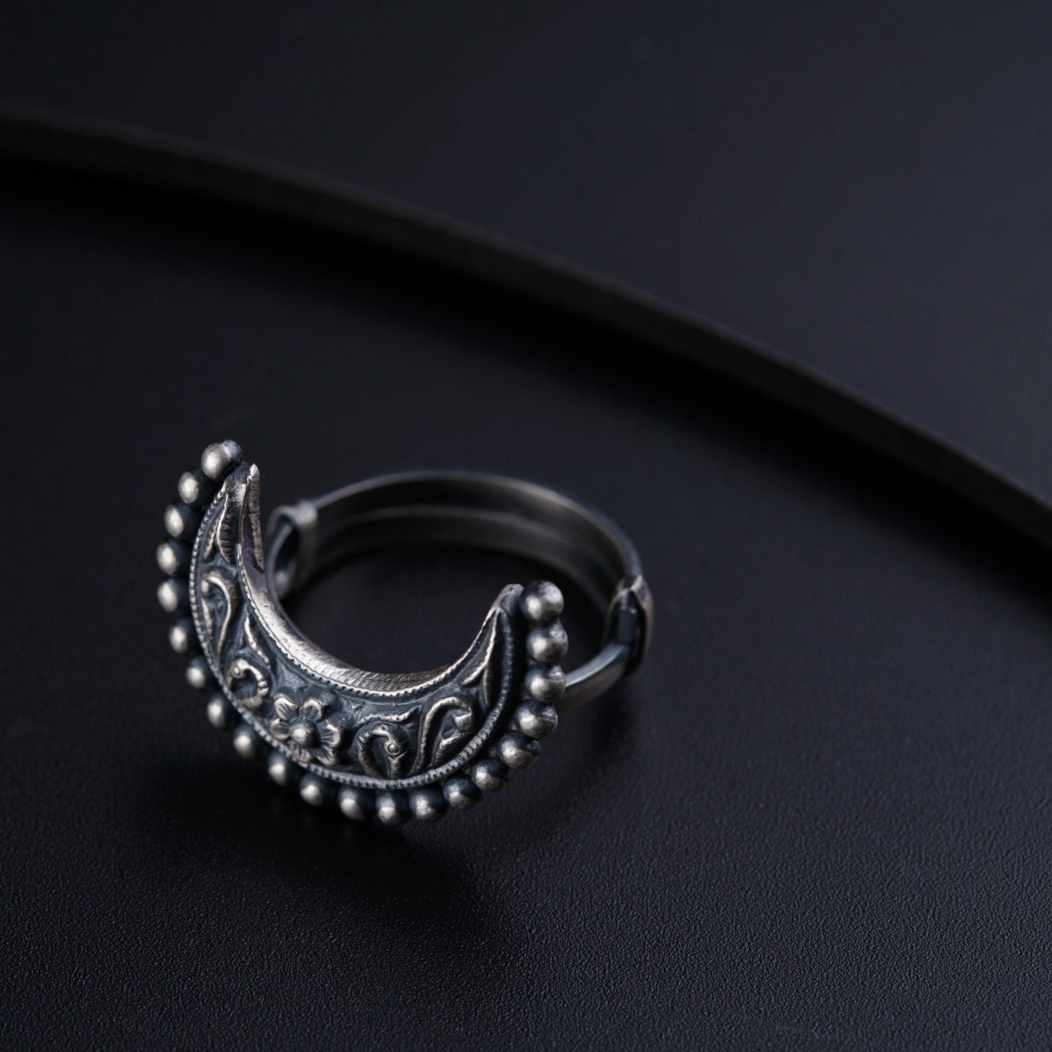 a close up of a ring on a black surface