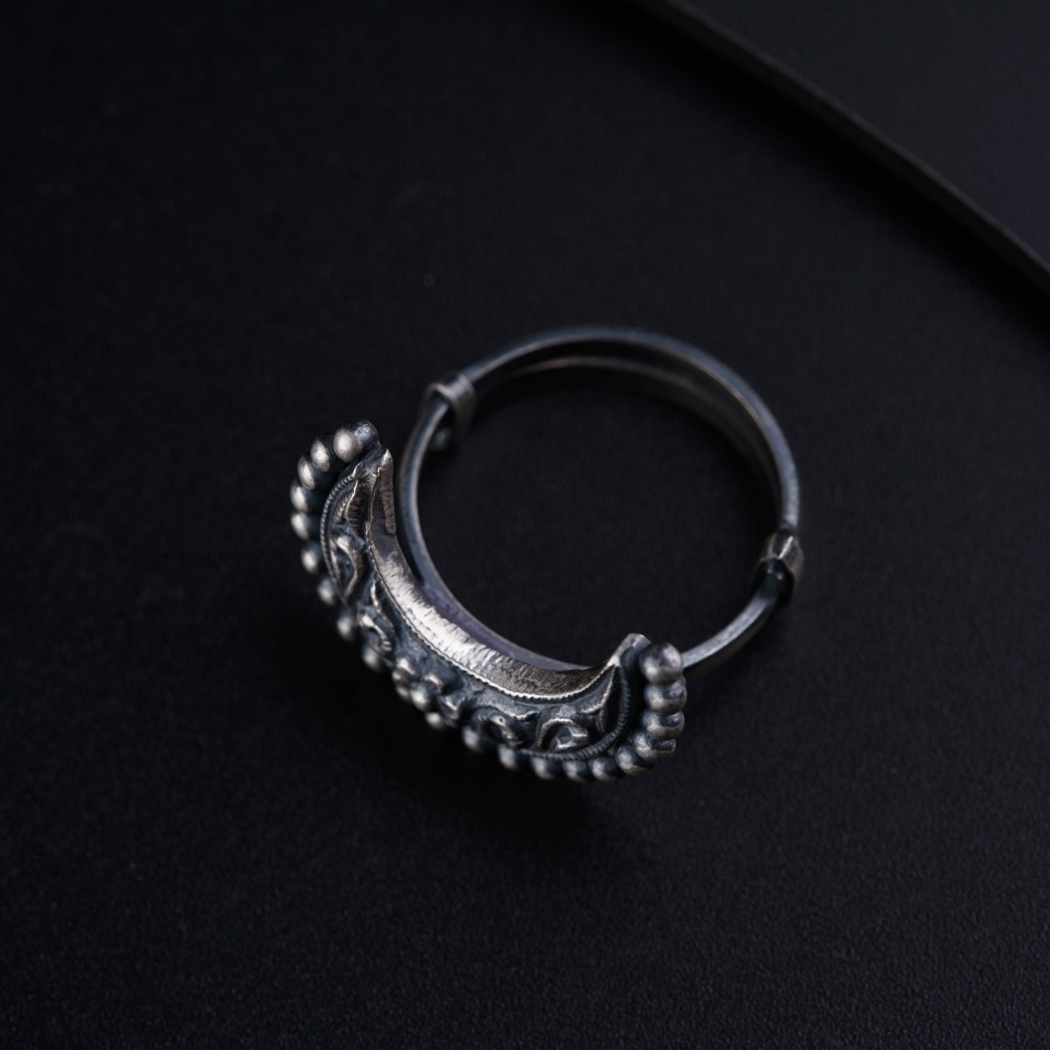 a close up of a ring on a black surface