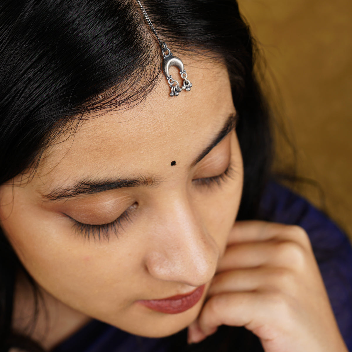 a close up of a person wearing a head piece